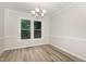 Dining room with a view of the large window, hard wood floors and decorative trim at 5604 Groomsbridge Ct, Raleigh, NC 27612