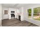 Bright kitchen featuring white cabinets, stainless steel appliances, and hardwood floors at 5604 Groomsbridge Ct, Raleigh, NC 27612