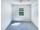 Bright bedroom featuring plush carpet, closet space, and natural light from one window at 5828 Brambleton Ave, Raleigh, NC 27610