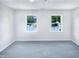 Bedroom featuring large windows, neutral walls, and carpet at 5828 Brambleton Ave, Raleigh, NC 27610