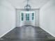Dining room with hardwood floors, modern lighting, and a large bay window providing natural light at 5828 Brambleton Ave, Raleigh, NC 27610