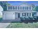Charming two-story home with a front yard, attached garage and dark shutters at 5828 Brambleton Ave, Raleigh, NC 27610