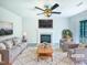 Bright living room featuring fireplace, ceiling fan, neutral walls, and a plush rug at 5828 Brambleton Ave, Raleigh, NC 27610