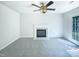 Cozy living room featuring fireplace, neutral walls, carpet, and a ceiling fan at 5828 Brambleton Ave, Raleigh, NC 27610