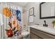 Bathroom with a modern vanity, framed mirror, patterned shower curtain, and bright lighting at 6 Landover Ct, Durham, NC 27713