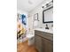 Bathroom with a modern vanity, framed mirror, patterned shower curtain, and bright lighting at 6 Landover Ct, Durham, NC 27713