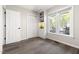 Bright bedroom with a built-in shelving unit, hardwood floors, a ceiling fan, closet, and natural light at 6 Landover Ct, Durham, NC 27713
