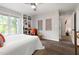 Comfortable bedroom featuring hardwood floors, neutral walls, a ceiling fan, built in shelving, and plenty of light at 6 Landover Ct, Durham, NC 27713