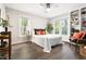 Bright bedroom showcases hardwood floors, neutral walls, a ceiling fan, and large windows with lots of natural light at 6 Landover Ct, Durham, NC 27713