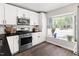 Bright kitchen features stainless steel appliances, white cabinetry, and a window overlooking the front yard at 6 Landover Ct, Durham, NC 27713