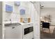 Efficient laundry room features a Maytag washer and dryer and shelving for organized storage at 6 Landover Ct, Durham, NC 27713