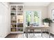 Sunlit home office features built-in shelving, natural light, and wood flooring at 6 Landover Ct, Durham, NC 27713