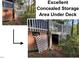 Concealed brick storage area under deck with white lattice and access panel at 6 Landover Ct, Durham, NC 27713