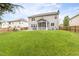 The large backyard shows a wooden fence, green grass, a screened porch, patio, and hot tub at 609 Conover Rd, Durham, NC 27703