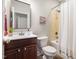 Well lit bathroom featuring neutral finishes, a tub-shower combination, and a wood vanity at 609 Conover Rd, Durham, NC 27703