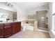 Primary bath features a double vanity, glass shower enclosure, and separate soaking tub at 609 Conover Rd, Durham, NC 27703