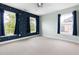 A carpeted bedroom with star decals and two windows providing natural light and outdoor views at 609 Conover Rd, Durham, NC 27703