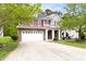 Charming two-story home featuring a stone facade, red shutters, and a spacious driveway at 609 Conover Rd, Durham, NC 27703