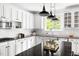 Kitchen showcasing white cabinets, a center island, and modern stainless steel appliances at 609 Conover Rd, Durham, NC 27703