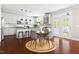 Open kitchen with white cabinets, a central island, and adjacent dining area at 609 Conover Rd, Durham, NC 27703