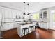 Modern kitchen featuring white cabinetry, an island with bar seating, and pendant lighting at 609 Conover Rd, Durham, NC 27703