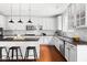 Well-lit kitchen with white cabinets, granite countertops, and modern stainless steel appliances at 609 Conover Rd, Durham, NC 27703
