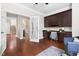 Bright office space features custom built-ins, hardwood floors, and a view of the home's entry stairs at 609 Conover Rd, Durham, NC 27703