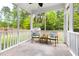 Relaxing screened porch with comfortable seating and views of the lush green backyard at 609 Conover Rd, Durham, NC 27703