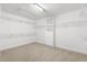 Spacious walk-in closet featuring custom shelving and ample storage options and carpet floors at 609 Conover Rd, Durham, NC 27703