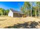 Back view of the single-Gathering home, including the wooden deck and spacious backyard at 61 Okra Ct, Selma, NC 27576