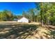 Expansive backyard with a view of the home and surrounding trees, providing privacy at 61 Okra Ct, Selma, NC 27576