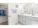 Bathroom featuring a double sink vanity and mirror, with access to closet at 61 Okra Ct, Selma, NC 27576
