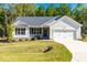 Inviting one-story home with a manicured lawn and an attached two-car garage at 61 Okra Ct, Selma, NC 27576