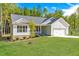 Beautiful single-story home with a large front yard and attached two-car garage at 61 Okra Ct, Selma, NC 27576