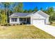 Charming single-story home with a well-maintained lawn and a welcoming front porch at 61 Okra Ct, Selma, NC 27576
