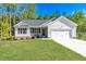 Charming single-story home with a manicured lawn and attached two-car garage at 61 Okra Ct, Selma, NC 27576