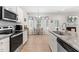 Bright eat-in kitchen featuring stainless appliances and granite counters, with a built-in desk area at 61 Okra Ct, Selma, NC 27576