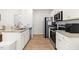 Modern kitchen featuring white cabinetry, granite countertops, and stainless steel appliances at 61 Okra Ct, Selma, NC 27576