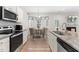 Bright kitchen with granite counters, stainless steel appliances, and an adjacent dining area with bay windows at 61 Okra Ct, Selma, NC 27576