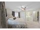 Primary bedroom with a ceiling fan, carpet, and beautiful upholstered bed with curtains and bright window light at 6212 Trevor Ct, Raleigh, NC 27613