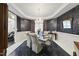 Elegant dining room with a chandelier, decorative wallpaper, and a formal dining set at 6212 Trevor Ct, Raleigh, NC 27613