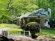 Brick home with charming details, manicured landscaping, and a bridge leading to the entrance at 6212 Trevor Ct, Raleigh, NC 27613