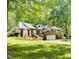 Beautiful brick home with mature trees, a front lawn, and a two-car garage at 6212 Trevor Ct, Raleigh, NC 27613