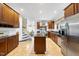 Spacious kitchen with wood cabinets, stainless steel appliances, and a central island at 6212 Trevor Ct, Raleigh, NC 27613