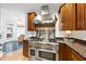 Close-up of gourmet kitchen featuring a stainless steel range and sleek vent hood at 6212 Trevor Ct, Raleigh, NC 27613