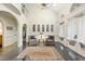 Bright living room with a chandelier, archway to the foyer, and patterned chairs at 6212 Trevor Ct, Raleigh, NC 27613