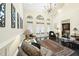 Sunlit living room featuring a chandelier and three large arched windows with white curtains at 6212 Trevor Ct, Raleigh, NC 27613