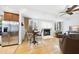 Open-concept living room featuring hardwood floors, a modern fireplace and dining table at 6212 Trevor Ct, Raleigh, NC 27613