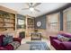 Home office with wood paneling, built in shelving and a ceiling fan at 6212 Trevor Ct, Raleigh, NC 27613