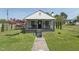 Charming single story home featuring a cozy front porch, beautiful lawn, and an inviting walkway at 729 S Carolina Ave, Henderson, NC 27536
